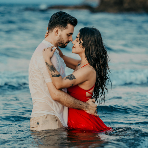 A Couple Standing in the Sea and Hugging 