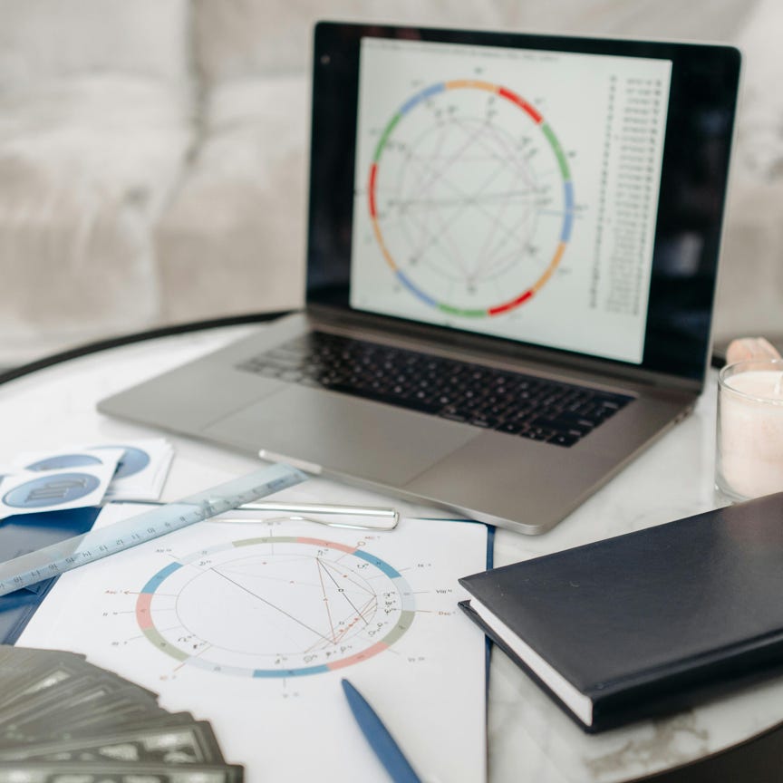 Horoscope Cards and Laptop on a Table 